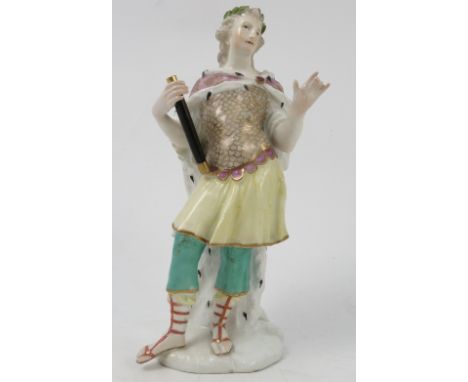 An 18th century Meissen figure, of a standing male figure, wearing an ermine lined cloak, with scale pattern to chest, holdin