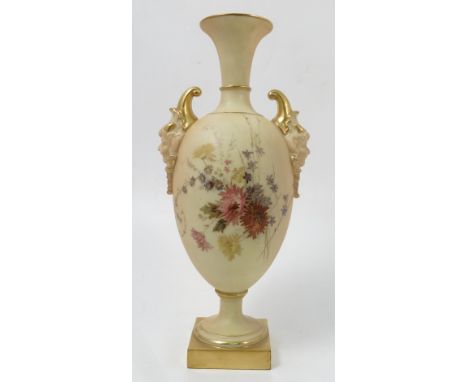 A Royal Worcester blush ivory vase, of baluster form, with mask handles, decorated with floral sprays, raised on a pedestal a