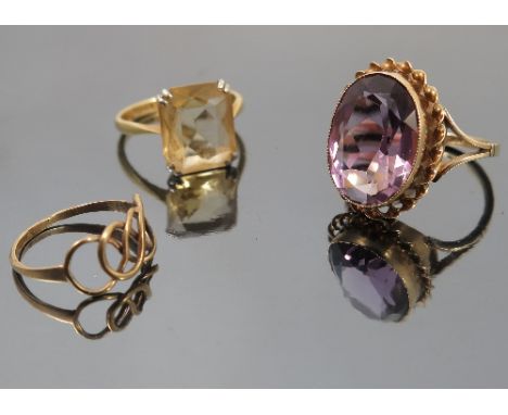 A single stone amethyst dress ring, together with a single stone citrine dress ring, and a plaited motif ring  Condition repo