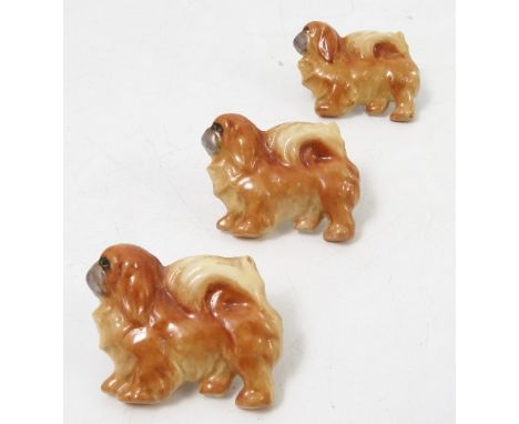 Three Royal Worcester brooches of Pekingese dogs, stamped Peke to the back, width 1.5ins