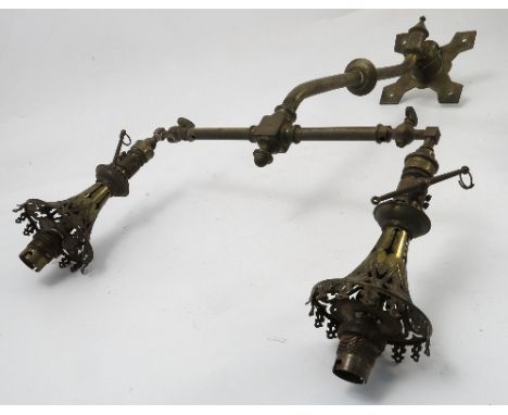 A pair of brass twin light gas light fittings, of T form, with regulator valves and pierced shades, converted to electricity,