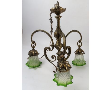 A brass Art Nouveau light fitting, the multi knopped column with flower petal decoration, having three scroll arms, with thre