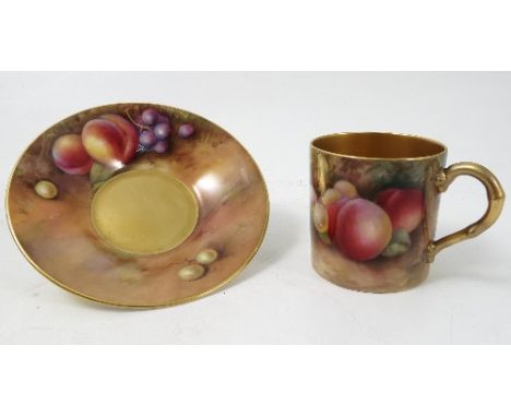 A Royal Worcester coffee can and saucer, hand painted with fruit to a mossy background by Moseley and Everett, dated 1928/9 C