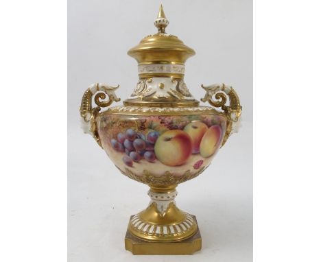 A Royal Worcester covered pedestal vase, hand painted all around with fruit to a mossy background by P Platt, with mask and s