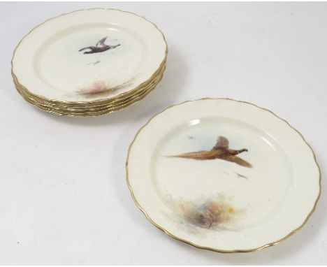 Six Royal Worcester plates, painted with different game birds in flight by Jas Stinton, with shaped borders, dated 1933, one 