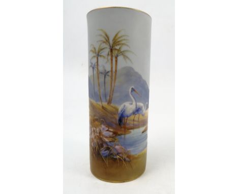 A Royal Worcester vase, of cylindrical form, decorated all around with storks watering in a desert oasis, in the manner of Po