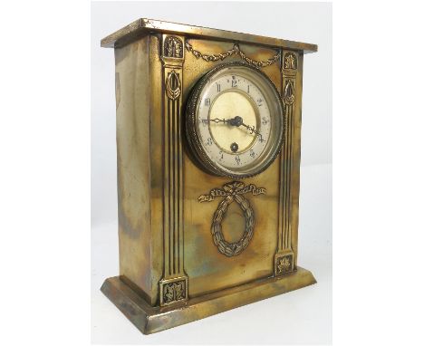 A brass cased mantel clock, the movement stamped REX, with white chapter ring, the case with embossed columns, harebells and 