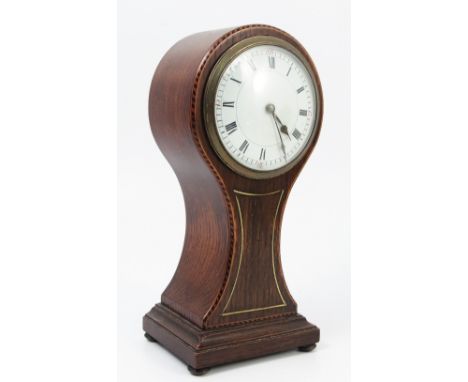 An Edwardian oak cased mantel clock, of balloon form, with white enamel dial, the case with chequer band inlay and brass line