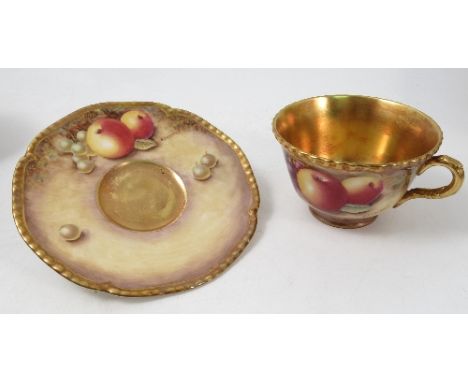 A Royal Worcester cup and saucer, the exterior of the cup and the saucer hand painted with fruit to a mossy background by Dry