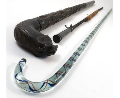 A glass walking stick, with pale blue, dark blue and red twist design, length 40ins, together with a carved ebony walking sti