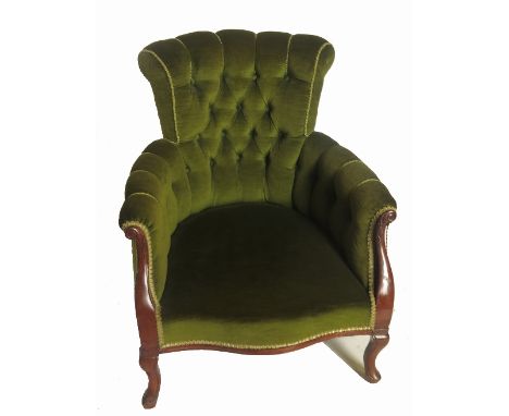 An Edwardian mahogany button back armchair, with showood frame, raised on short cabriole legs