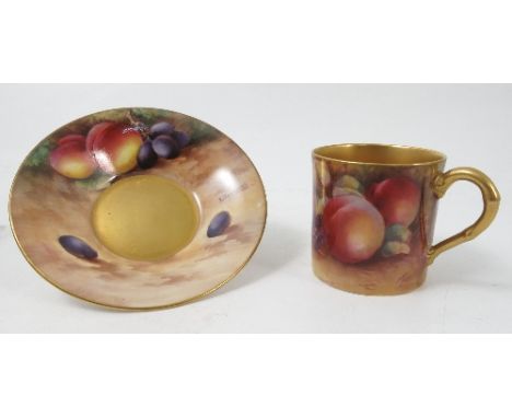 A Royal Worcester coffee can and saucer, hand painted with fruit to a mossy background by Moseley and Townsend, dated 1929 Co