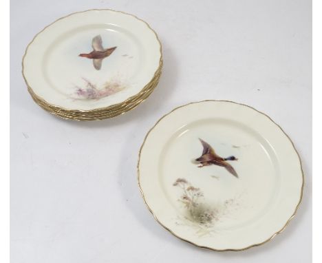 Six Royal Worcester plates, painted with different game birds in flight by Jas Stinton, with shaped borders, dated 1933, diam