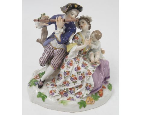 A 20th century Continental porcelain figure group, of a family group with the man playing a flute, the woman holding the shee