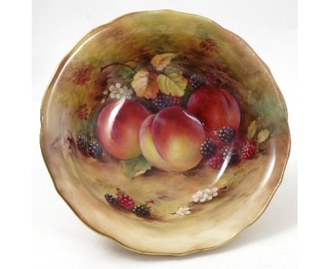 A Royal Worcester bowl, the interior hand painted with fruit to a mossy background by H Aryton, the exterior with blush ivory