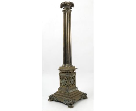 A brass table light, with leaf sconce to a cluster column, on a square pedestal pierced with rosettes and leaves, to a steppe