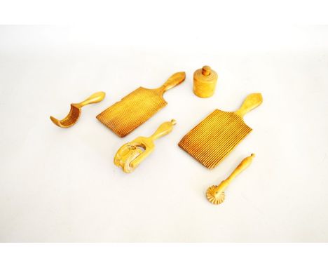 A collection of Victorian and Edwardian sycamore and treen butter moulds and stamps, including a pair of butter pats, 23cm, a