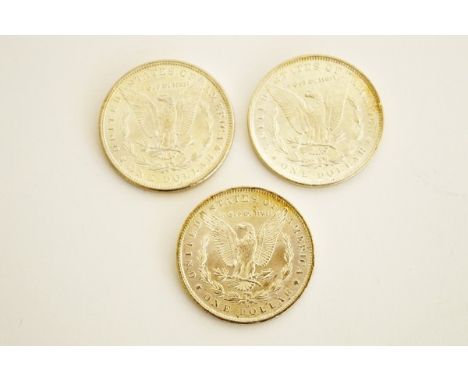 Three Morgan head silver dollars, dated 1885 and two 1888, one with New Orleans mint mark