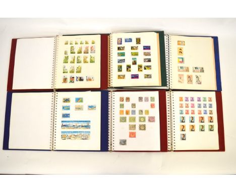 Seventeen stamp albums containing mostly Commonwealth stamps, countries include Kenya, Hong Kong, Heligoland, Nigeria, Uganda