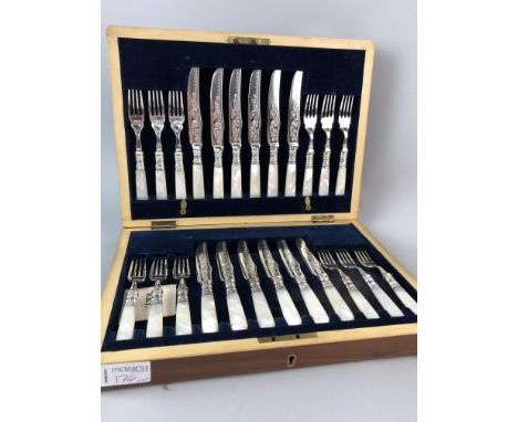 SET OF TWELVE MOTHER OF PEARL HANDLED DESSERT KNIVES AND FORKS IN A FITTED CASE, along with a set of carvers in fitted case, 