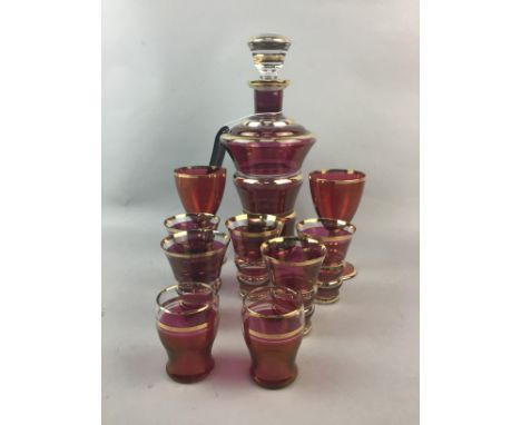 CRANBERRY AND GILT DECANTER AND GLASSES, 27cm high, along with similar tumblers and stemmed glasses