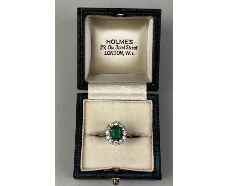 A 18CT WHITE GOLD RING SET WITH AN EMERALD AND DIAMONDSWeight: 3.5gms