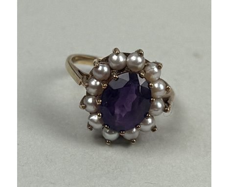 A 9CT GOLD RING SET WITH AN AMETHYST AND SEED PEARLSWeight: 3.5gms