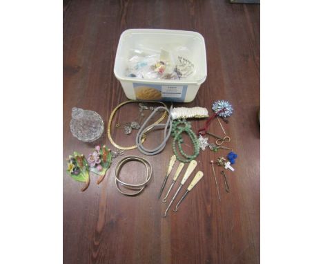 A collection of costume jewellery includes a glass pear trinket pot, vintage bone manicure set, hat pins, silver chain, cuff 