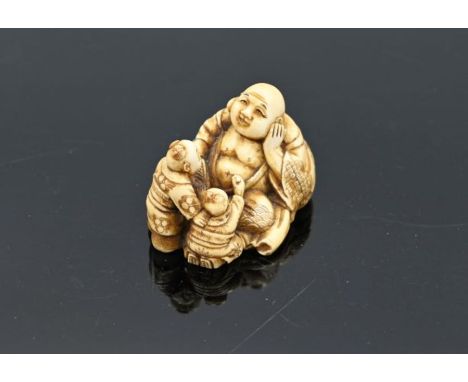 Japanese ivory netsuke of Buddha with children, signed to base, approx 40.5g