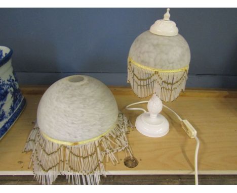 A beaded glass light shade and matching lamp