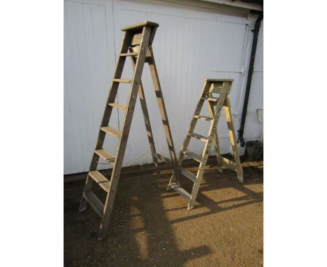 2 Vintage wooden step ladders, one with name plate, the other with advertising . Both for display purposes only