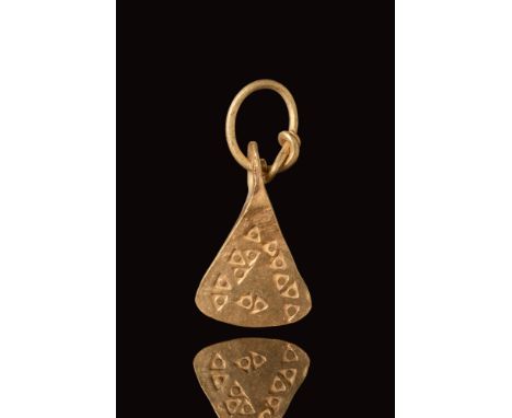 Ca. AD 800 - 1100. A gold Viking pendant in the shape of an axe head decorated with triangles, set with gold intertwining fin