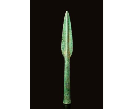 Ca. 800 - 500 BC. A Greek bronze age spearhead. The mid-rib features a raised central ridge and a long socket cone. This is a