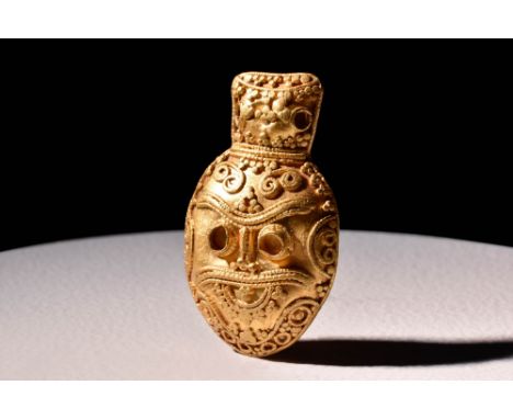 Ca. AD 900 - 1000.A gold pendant in the shape of Odin's head. It features intricate gold filigree beading that forms the faci