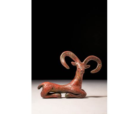 Ca. 1200 - 800 BC. A beautiful figurine of a recumbent stag represented with body in profile while the head is facing front. 