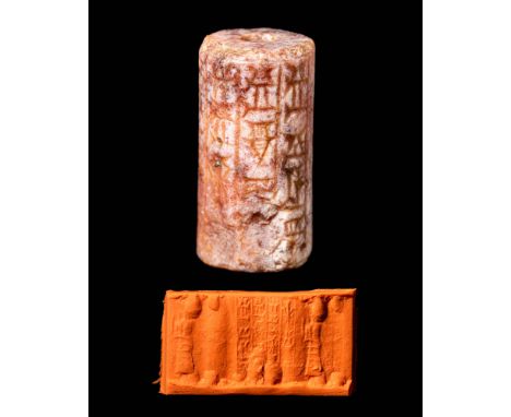 Ca. 1900 - 1700 BC.An old Babylonian white and pink stone cylinder seal depicting a single standing Lamma goddess in a horned