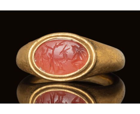 Ca. AD 100 - 300. A Roman gold ring with D shaped band with flattened soulders and an oval bezel securing an helliptical carn
