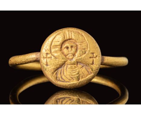 Ca. AD 500 - 700. A gold Byzantine ring with a round bezel engraved with a Saint wearing a tunic and Clamyd around the should