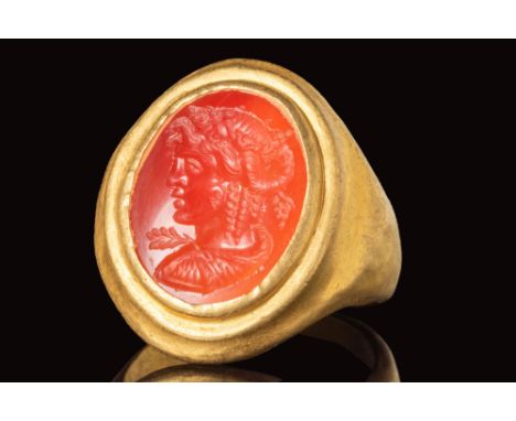 Ca. AD 100 - 300. A Roman gold ring with D-shaped band which is flattened towards the shoulders to form an oval bezel securin