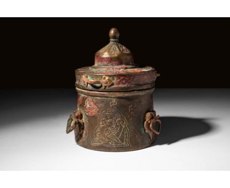 Ca. AD 1100 - 1300. A charming Seljuk cast-brass inkwell with a cylindrical body and thin-lipped lid. A pair of horizontal ha
