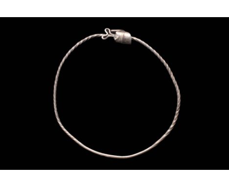Ca. AD 900 - 1100. A beautiful, solid silver neck torc featuring a twisted rope-like effect on the body and decorative termin