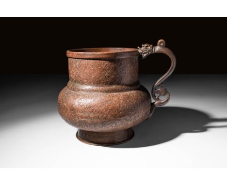 Ca. AD 1400 - 1500. A Timurid copper alloy globular-shaped jug resting on a short circular foot, rising to narrow shoulders a