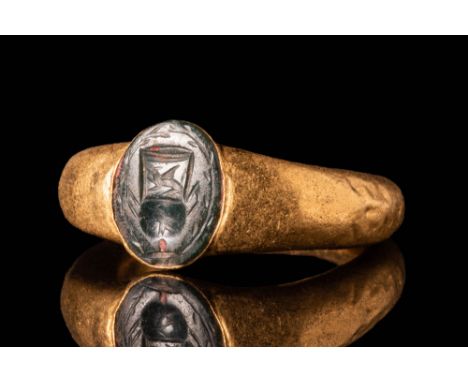 Ca. AD 100 - 300. A Roman 23ct gold ring with an intaglio depicting an altar under floral and animal motifs. For similar see: