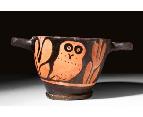 Ca. 450 - 400 BC. A red-figure terracotta skyphos with twin-loop handles, a deep cup and a low flanged base. Each side of the