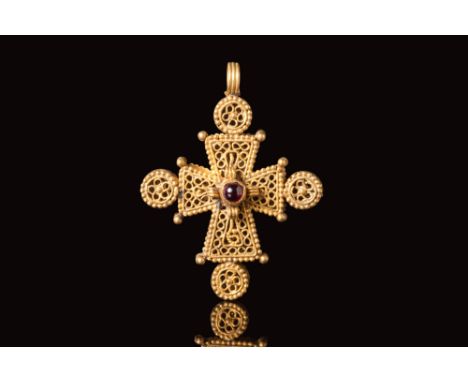 Ca. AD 600 - 700. A gold Byzantine open work cross with beaded decoration. The crucifix is represented with circlular swirlin