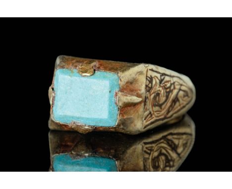 Ca. AD 1200 . A beautiful Islamic Seljuk gold ring set with a pale green rectangular cabochon. The hoop is decorated with nie