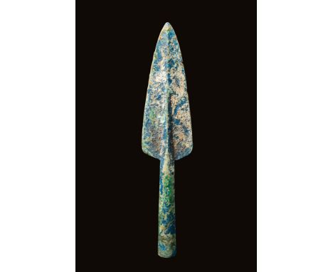 Ca. 800 - 500 BC. A Greek bronze age spearhead. The mid-rib features a raised central ridge and a long socket cone. This is a