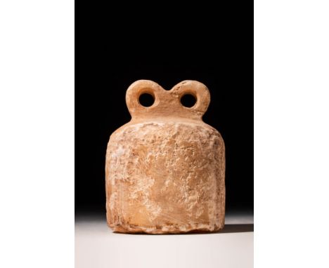 Ca. 3300 - 3000 BC.A stunning and abstract eye idol, moulded from creamy red clay with areas of brown and salmon-pink coloura
