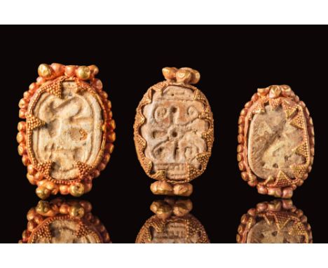 Ca. 2055 - 1790 BC. Set of three middle Kigndom steatite scarabs decorated with geometric symbols and inscriptions, all set i