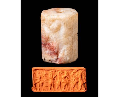Ca. 1150 - 1050 BC.A stunning white Babylonian stone cylinder seal depicting a horned animal with three heads before a tree. 